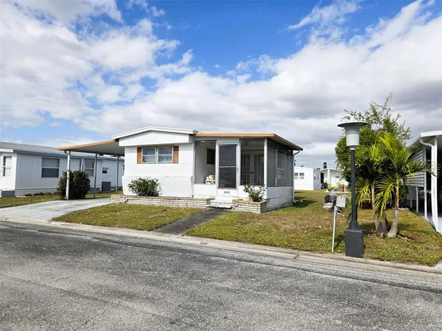 a front view of house with yard outdoor seating and barbeque oven
