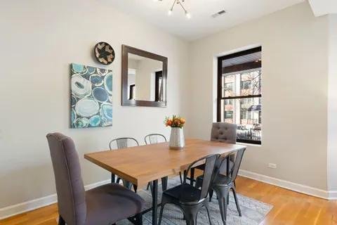 a view of a dining room with furniture and wooden floor