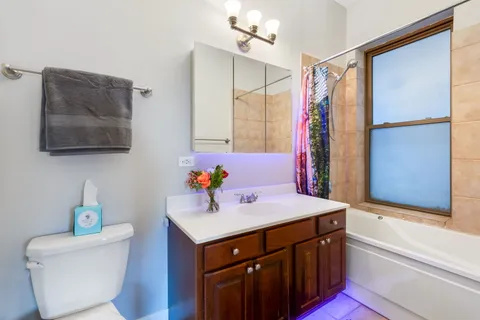 a bathroom with a sink mirror vanity and toilet