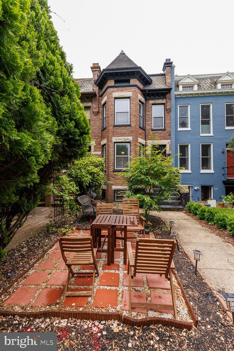 1437 East Capitol Street Southeast, Unit B Washington, DC 20003 - Photo 1 of 20 a front view of house with yard outdoor seating and covered with trees