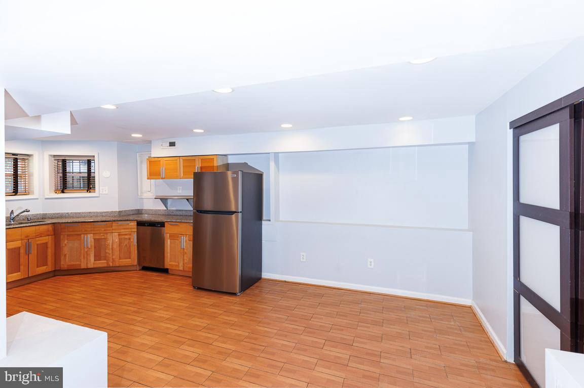1437 East Capitol Street Southeast, Unit B Washington, DC 20003 - Photo 7 of 20 a view of a kitchen with wooden floor and electronic appliances