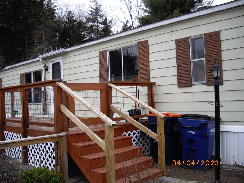 198 Sinpatch Road Amenia, NY 12592 - Photo 19 of 35 a view of a house with wooden stairs and a small yard