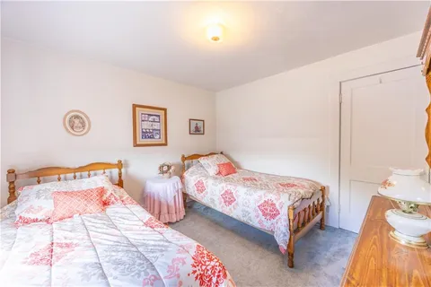 a bedroom with two beds and a lamp