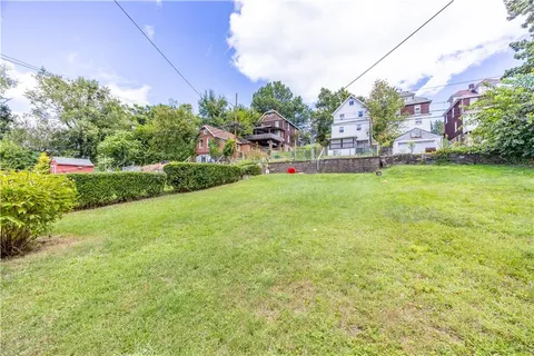 a view of a garden with a building in the background