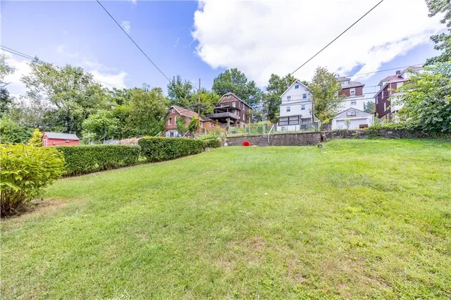 a view of a garden with a building in the background