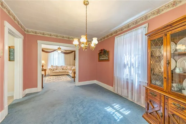 a view of a big room with chandelier windows and a chandelier