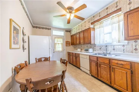 a large kitchen with stainless steel appliances granite countertop a sink a stove a dining table and chairs