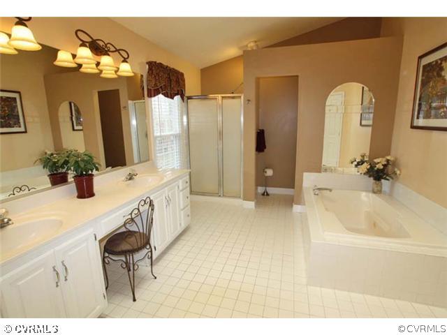 13904 Eastbluff Road Midlothian, VA 23112 - Photo 11 of 12 a bathroom with a tub a sink and a mirror