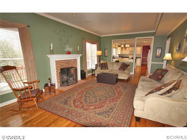 13904 Eastbluff Road Midlothian, VA 23112 - Photo 9 of 12 a living room with furniture a fireplace and a table