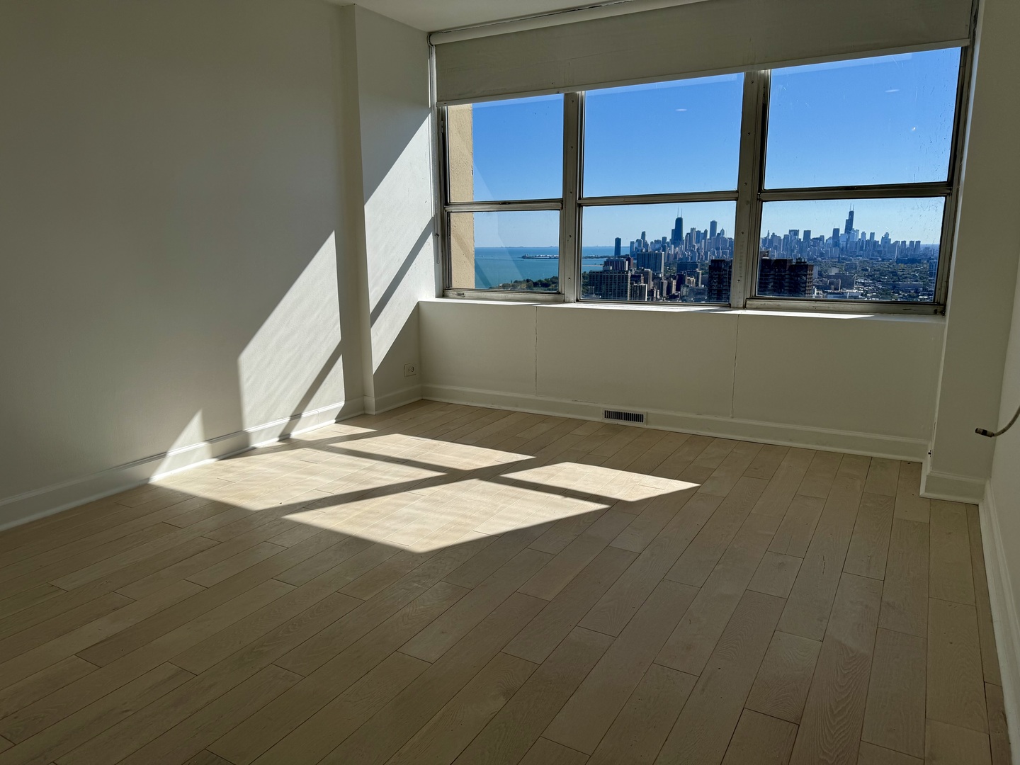 655 West Irving Park Road, Unit 5513 Chicago, IL 60613 - Photo 13 of 17 a view of a room with wooden floor