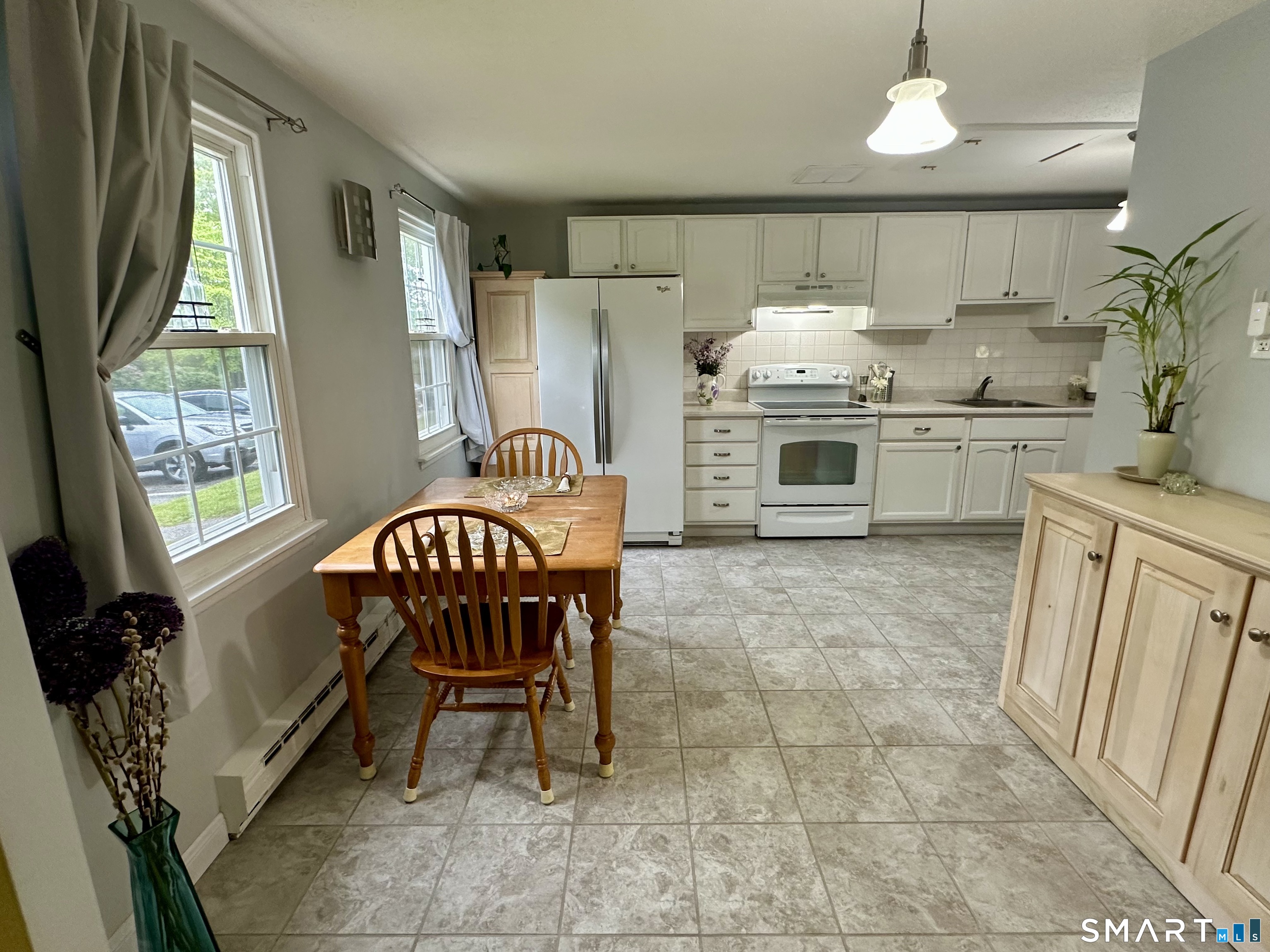 2 Lakeside Drive, Unit M Ledyard, CT 06339 - Photo 5 of 38 a kitchen with granite countertop a sink chairs and cabinets