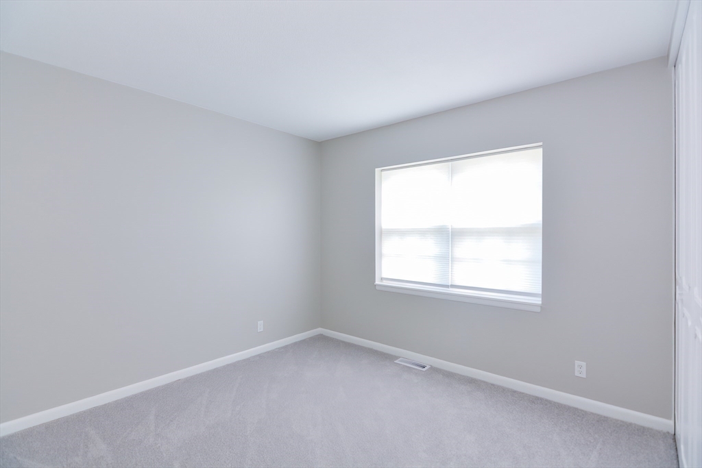 141 Lake Shore Road, Unit 1 Boston, MA 02135 - Photo 19 of 42 an empty room with a window
