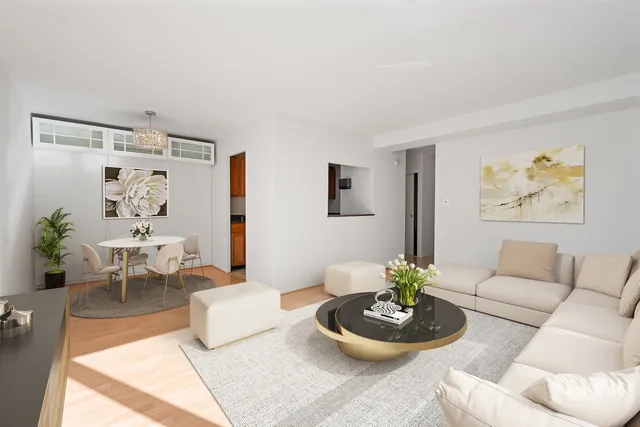 a living room with furniture and a dining table