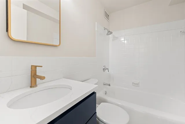 a bathroom with a sink a toilet and bathtub