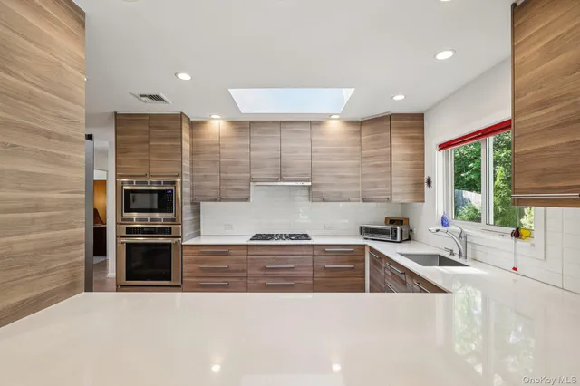 a kitchen with stainless steel appliances kitchen island granite countertop a sink and cabinets