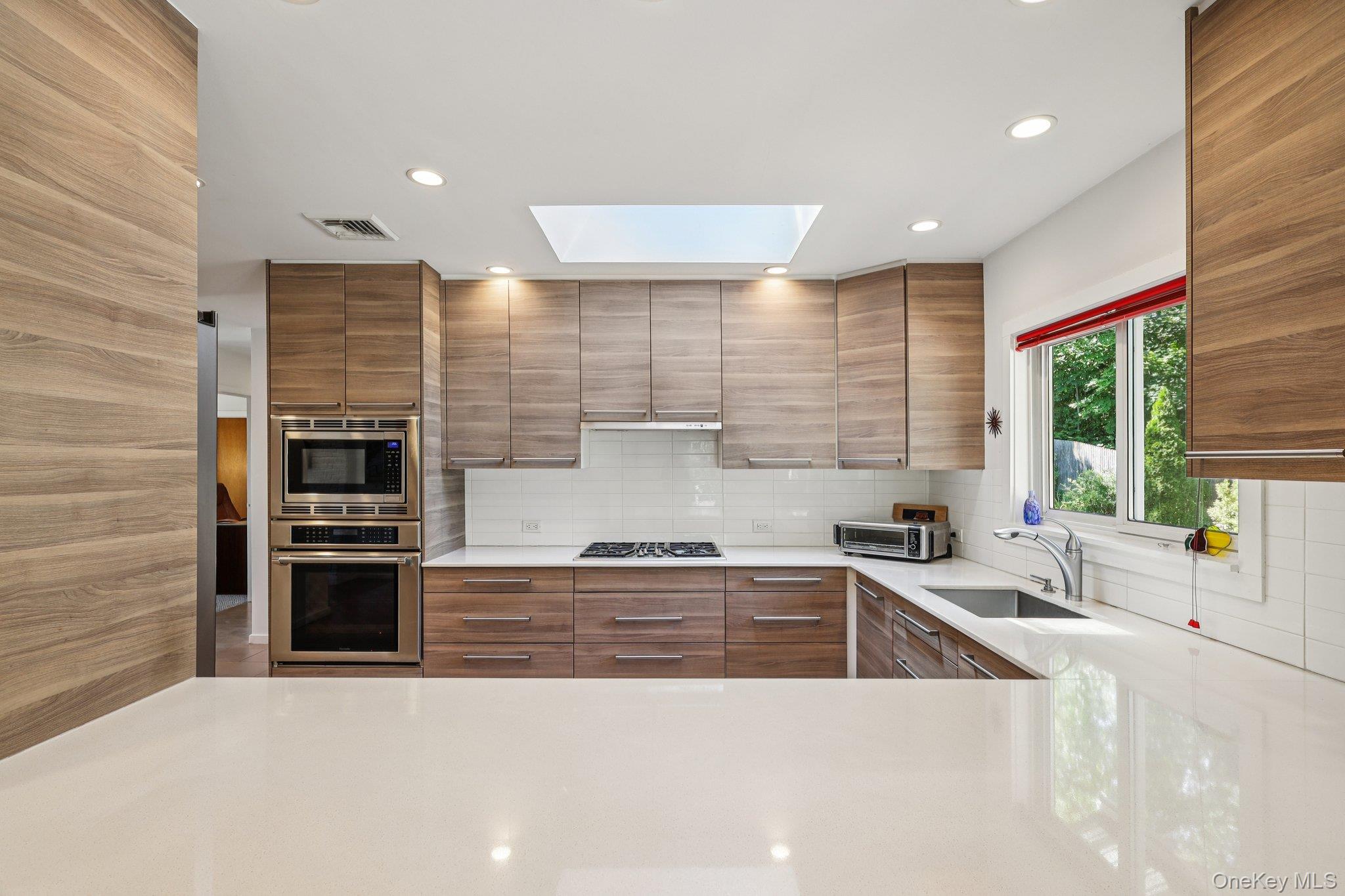 a kitchen with stainless steel appliances kitchen island granite countertop a sink and cabinets