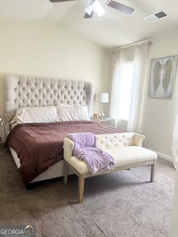 a bedroom with a bed and lamp
