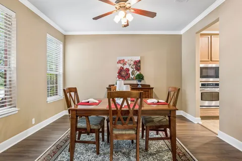 a view of a dining room with furniture and wooden floor