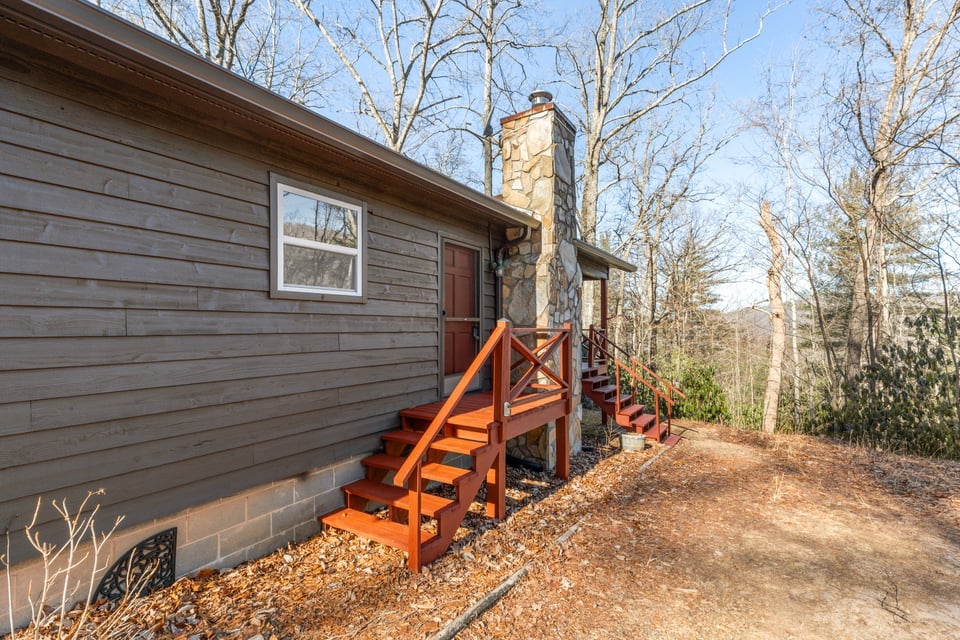 795 Buck Falls Road Highlands, NC 28741 - Photo 4 of 39 Side exterior view featuring new windows, new gutters, and mountain cabin siding freshly painted with a dark trending complimentary colo