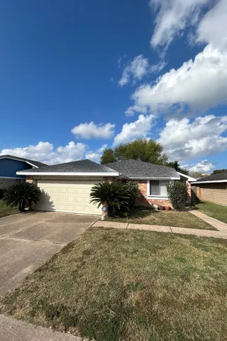 a view of house with yard and chair