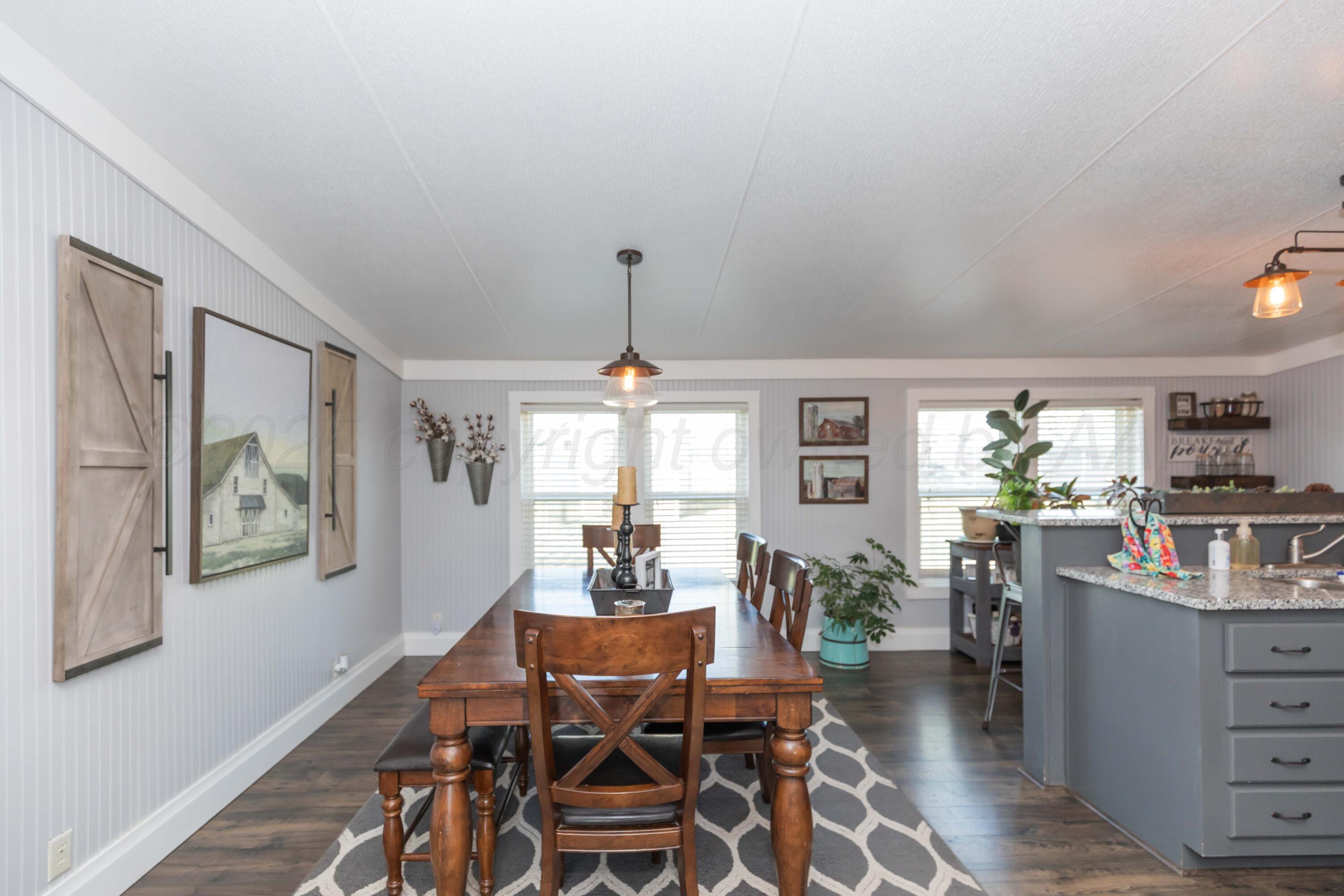 7501 Lobo Trail Amarillo, TX 79124 - Photo 11 of 49 a view of a dining room with furniture window and wooden floor