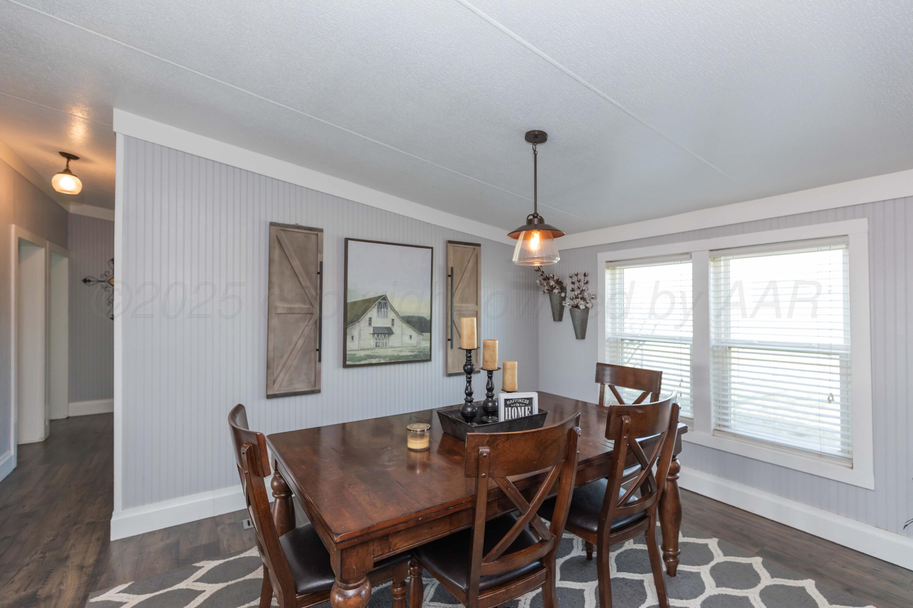 7501 Lobo Trail Amarillo, TX 79124 - Photo 12 of 49 a view of a dining room with furniture window and wooden floor