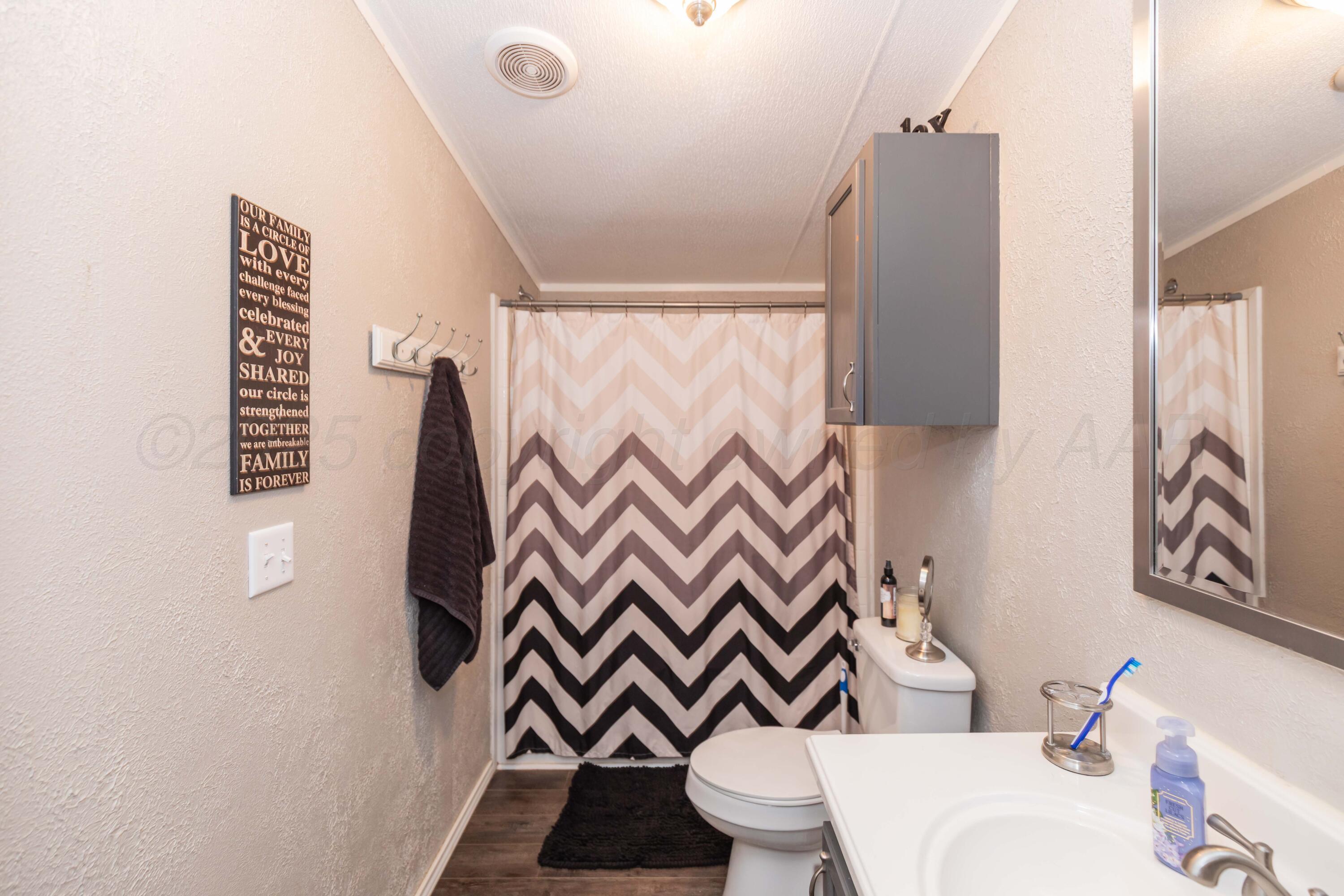 7501 Lobo Trail Amarillo, TX 79124 - Photo 29 of 49 a bathroom with a sink toilet and shower