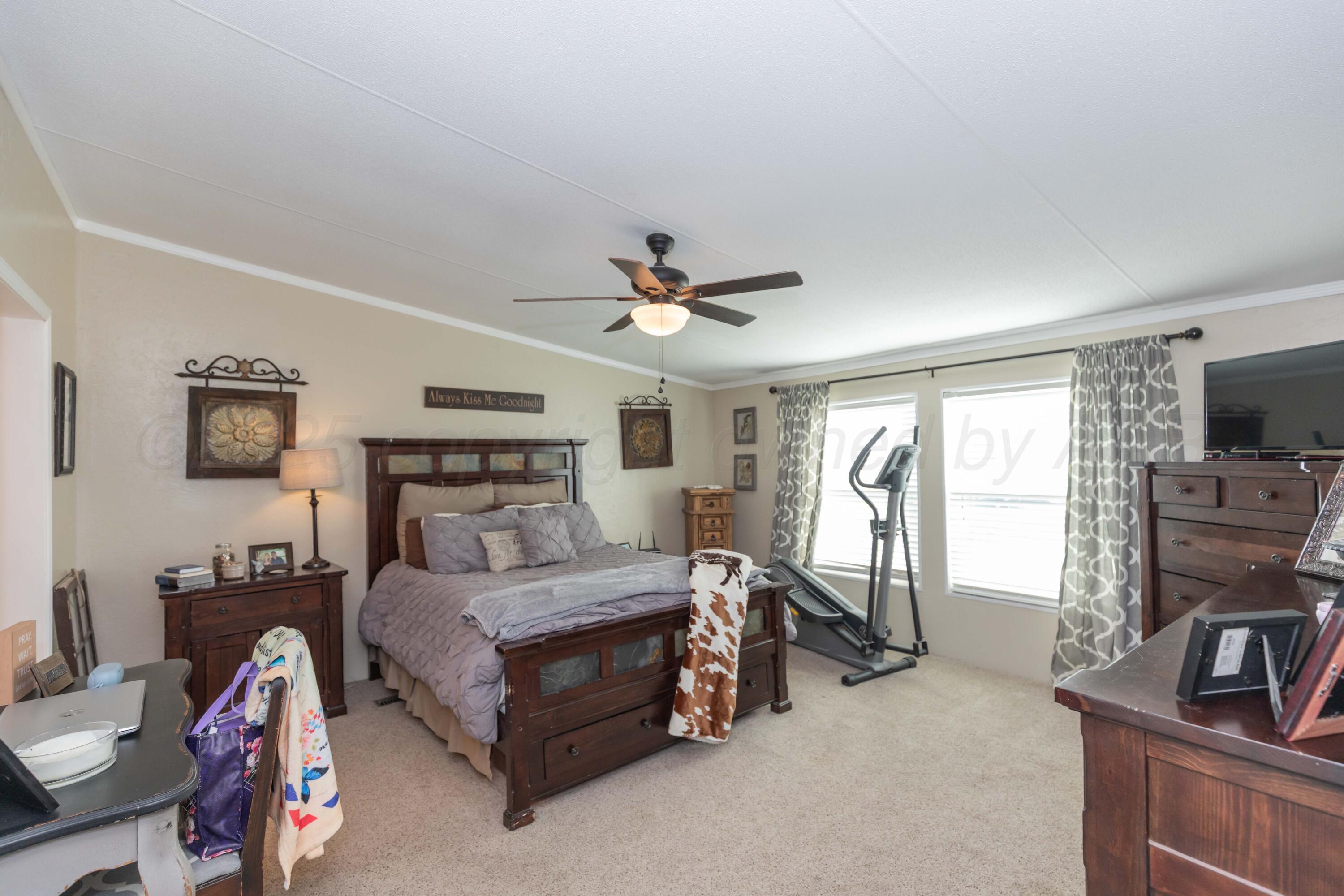 7501 Lobo Trail Amarillo, TX 79124 - Photo 33 of 49 a living room with furniture a flat screen tv and a window