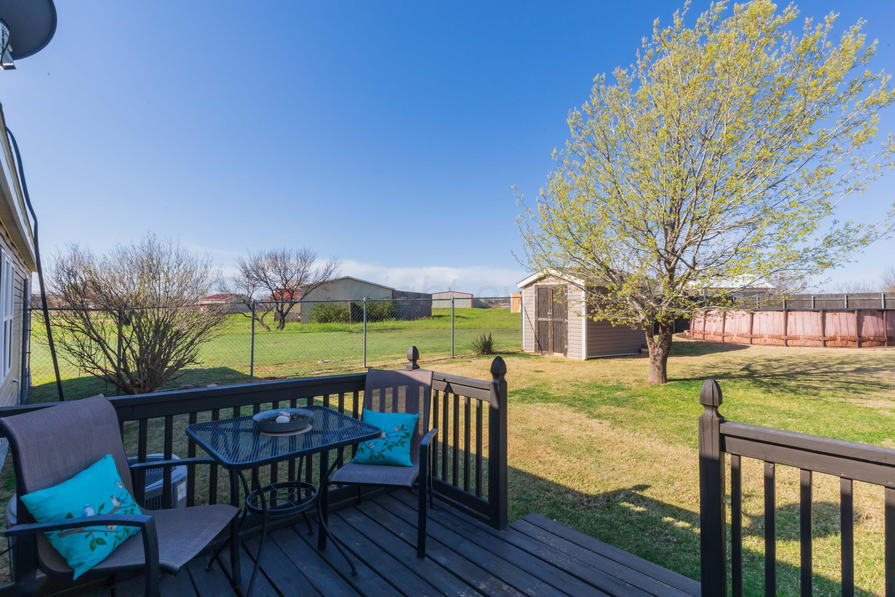 7501 Lobo Trail Amarillo, TX 79124 - Photo 42 of 49 a view of a roof deck with table and chairs and wooden floor