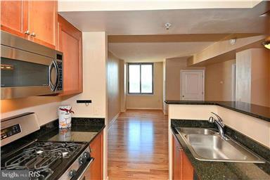 851 North Glebe Road, Unit 1513 Arlington, VA 22203 - Photo 8 of 30 Kitchen has breakfast bar, open to living space