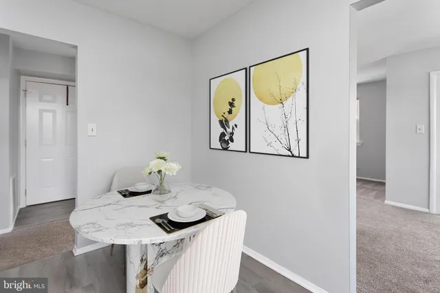 a dining room with furniture and wooden floor