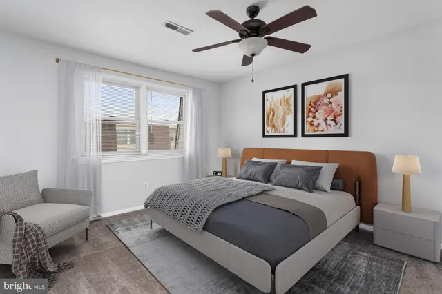 an empty room with chandelier fan