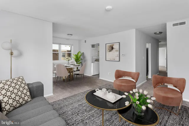 a living room with furniture and a potted plant