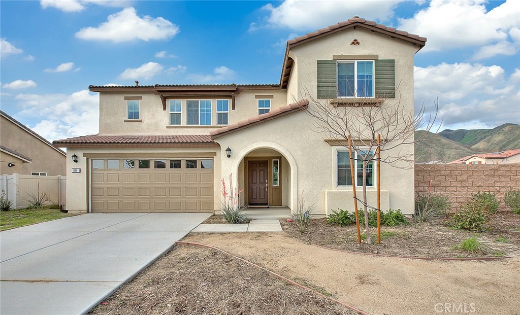 a front view of a house with a yard and garage