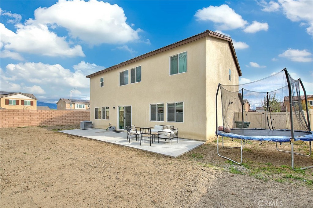 885 Canopy Lane San Jacinto, CA 92583 - Photo 21 of 75 a backyard of a house with table and sofas