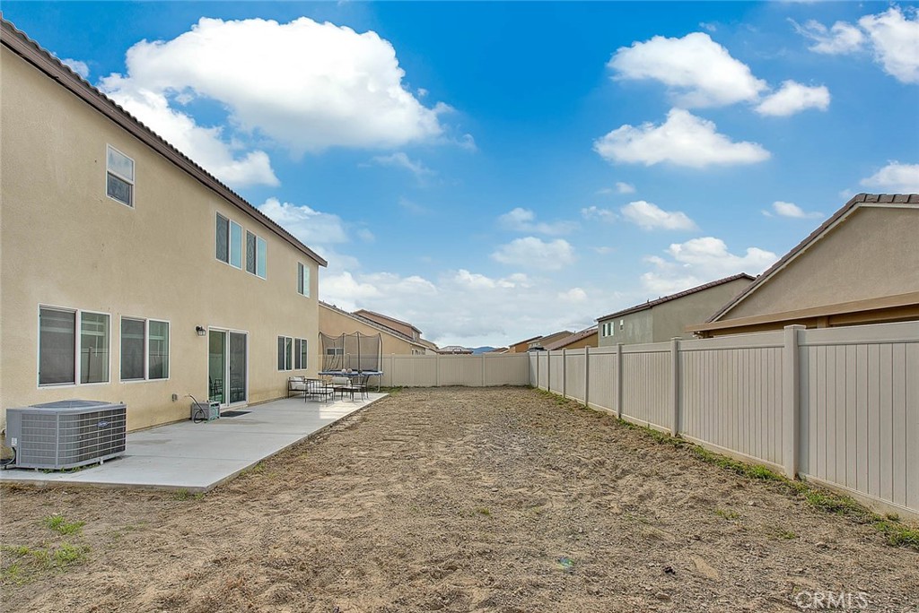 885 Canopy Lane San Jacinto, CA 92583 - Photo 24 of 75 a view of a white house with a yard
