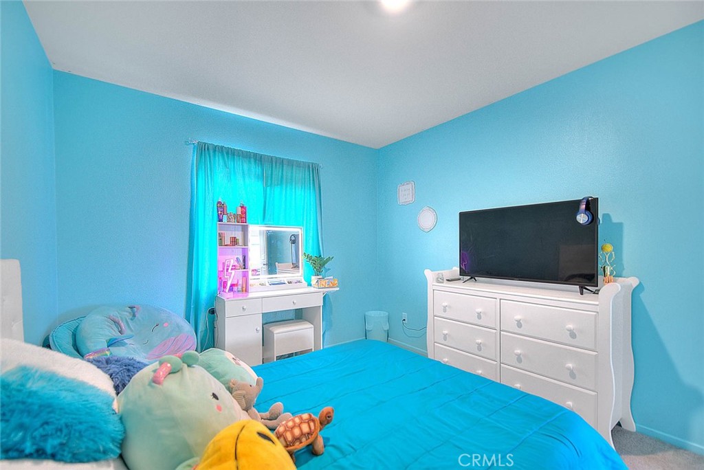 885 Canopy Lane San Jacinto, CA 92583 - Photo 33 of 75 a bedroom with a bed and a flat screen tv