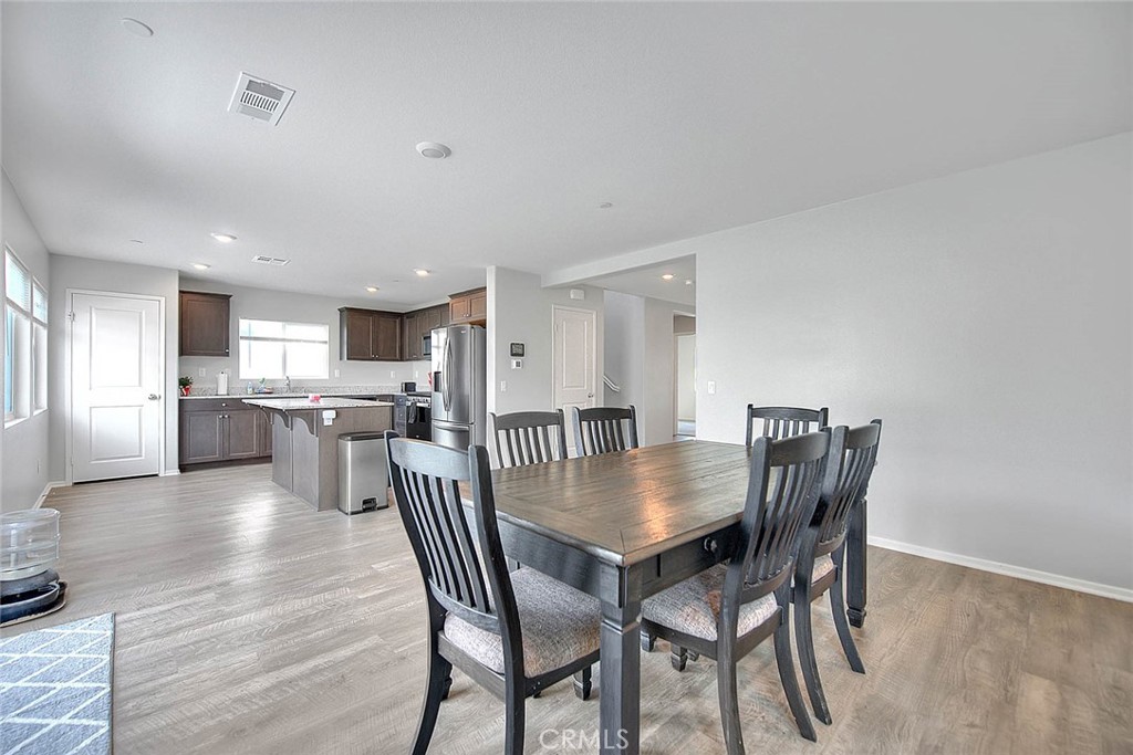 885 Canopy Lane San Jacinto, CA 92583 - Photo 39 of 75 a dining room with furniture and wooden floor