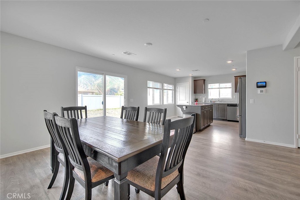 885 Canopy Lane San Jacinto, CA 92583 - Photo 40 of 75 a view of a dining room and livingroom with furniture a rug and a painting