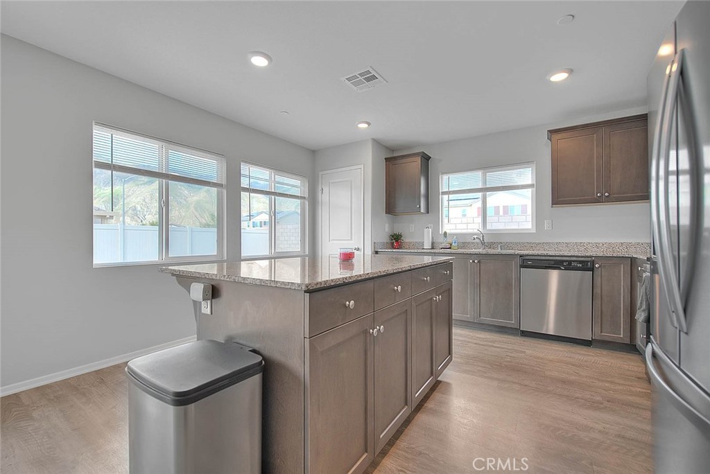885 Canopy Lane San Jacinto, CA 92583 - Photo 45 of 75 a kitchen with granite countertop a sink stove cabinets and refrigerator
