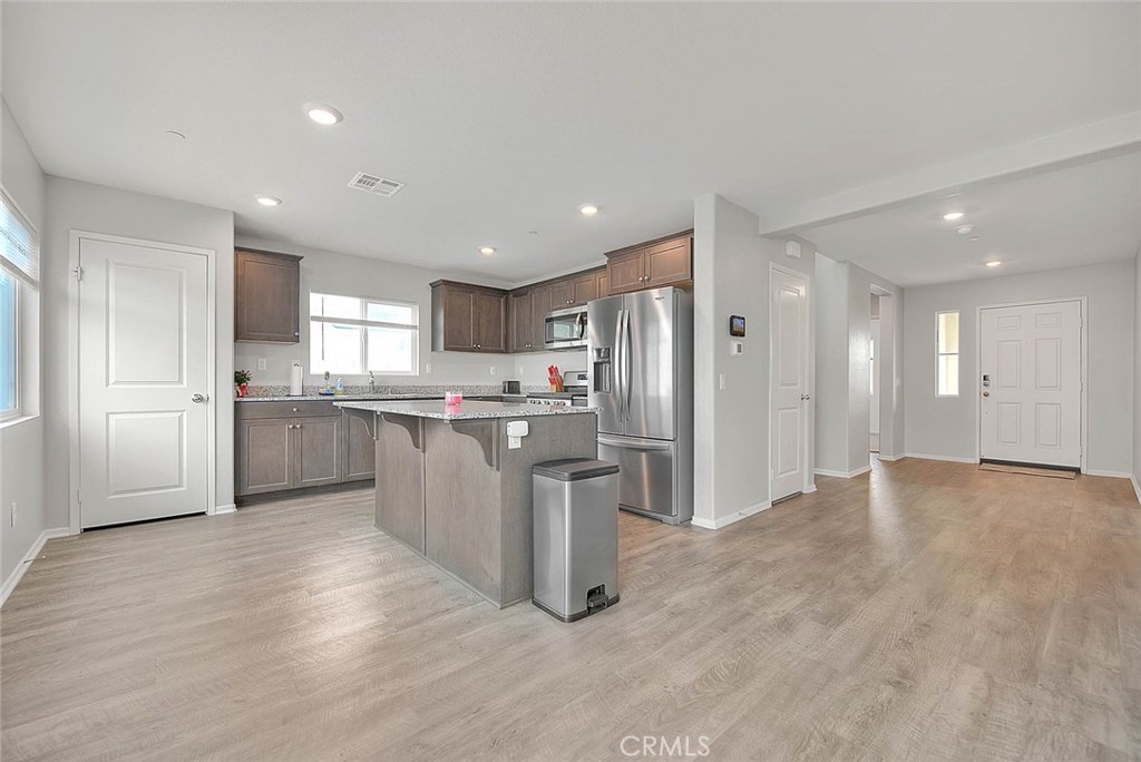 885 Canopy Lane San Jacinto, CA 92583 - Photo 47 of 75 a view of kitchen with stainless steel appliances granite countertop a refrigerator a sink dishwasher and a oven with white cabinets