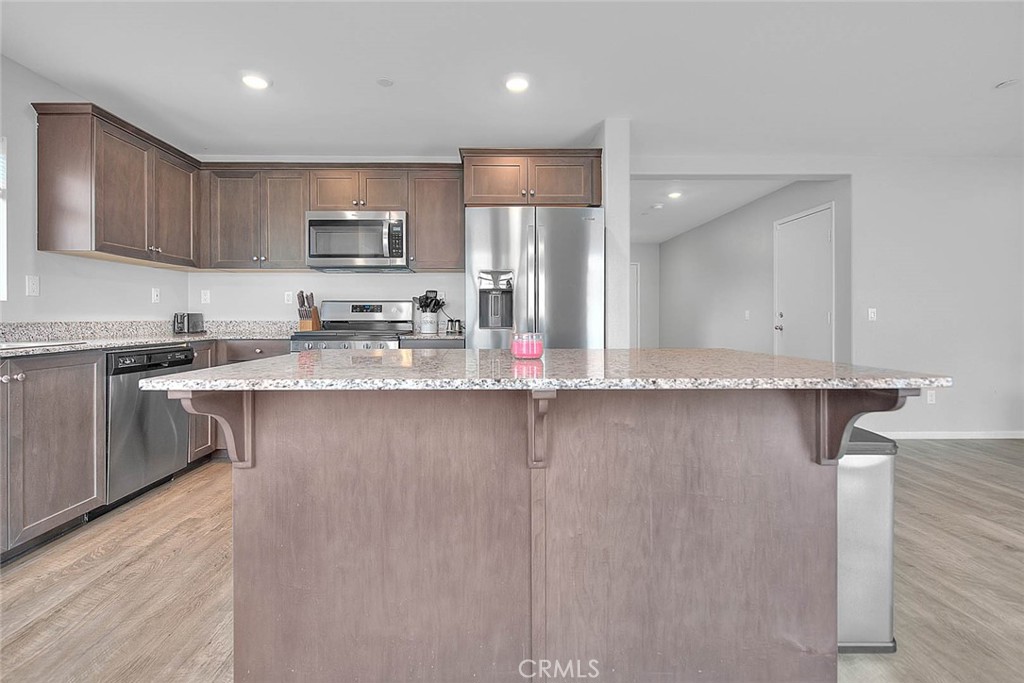885 Canopy Lane San Jacinto, CA 92583 - Photo 48 of 75 a kitchen with stainless steel appliances granite countertop a sink refrigerator stove and microwave