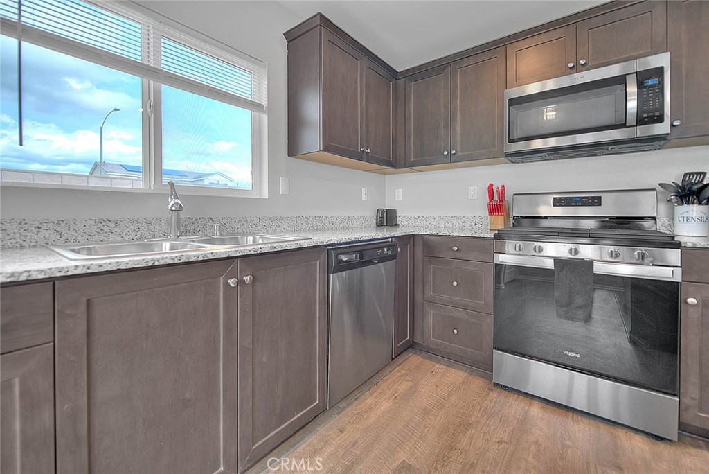885 Canopy Lane San Jacinto, CA 92583 - Photo 52 of 75 a kitchen with granite countertop cabinets stainless steel appliances and a sink