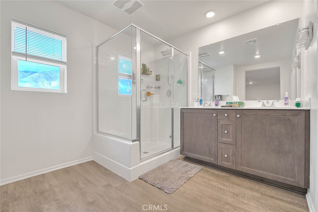 885 Canopy Lane San Jacinto, CA 92583 - Photo 68 of 75 a bathroom with a sink a mirror and a shower