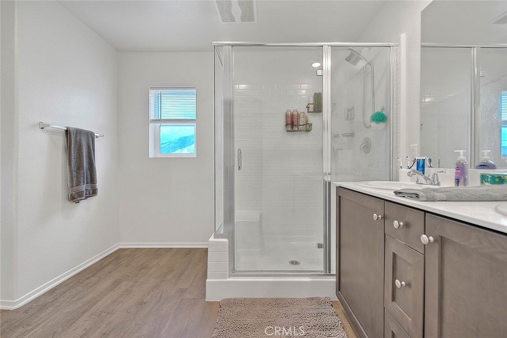 885 Canopy Lane San Jacinto, CA 92583 - Photo 69 of 75 a bathroom with a shower sink and mirror