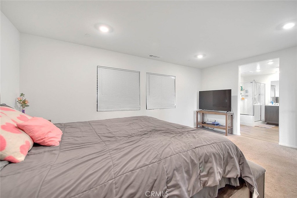 885 Canopy Lane San Jacinto, CA 92583 - Photo 73 of 75 a bedroom with a bed and a flat screen tv