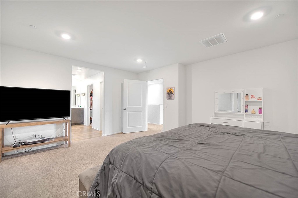 885 Canopy Lane San Jacinto, CA 92583 - Photo 75 of 75 a bedroom with a bed and a flat screen tv