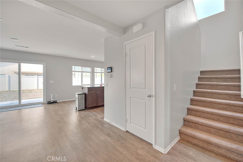 885 Canopy Lane San Jacinto, CA 92583 - Photo 10 of 75 a view of an empty room with wooden floor and windows