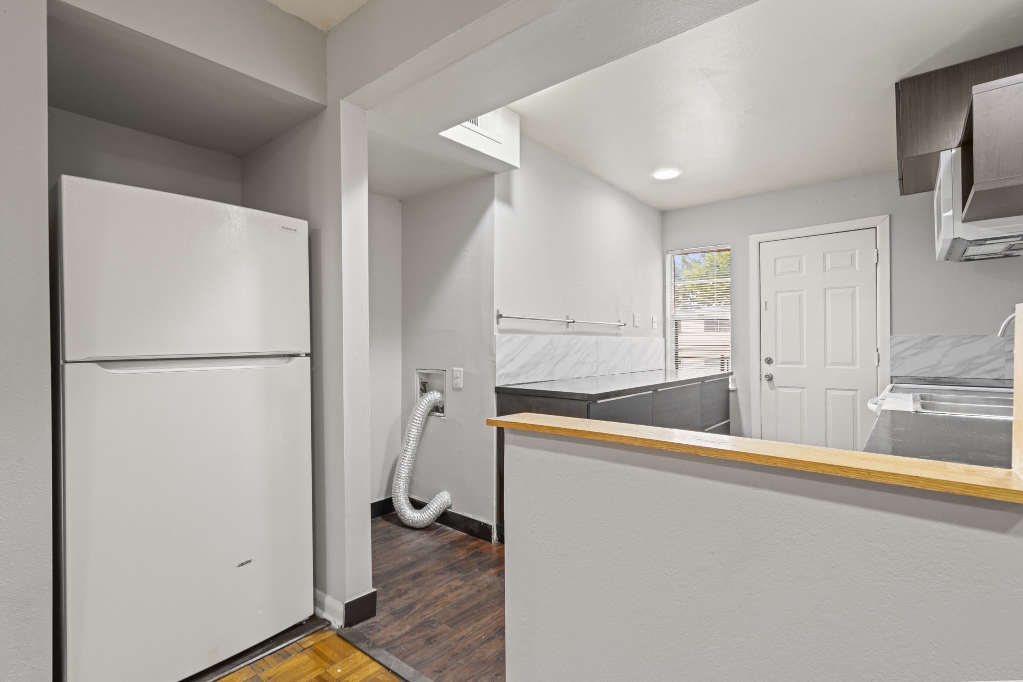 11607 Chimney Rock Road, Unit C Houston, TX 77035 - Photo 11 of 18 a kitchen with stainless steel appliances a refrigerator and a sink
