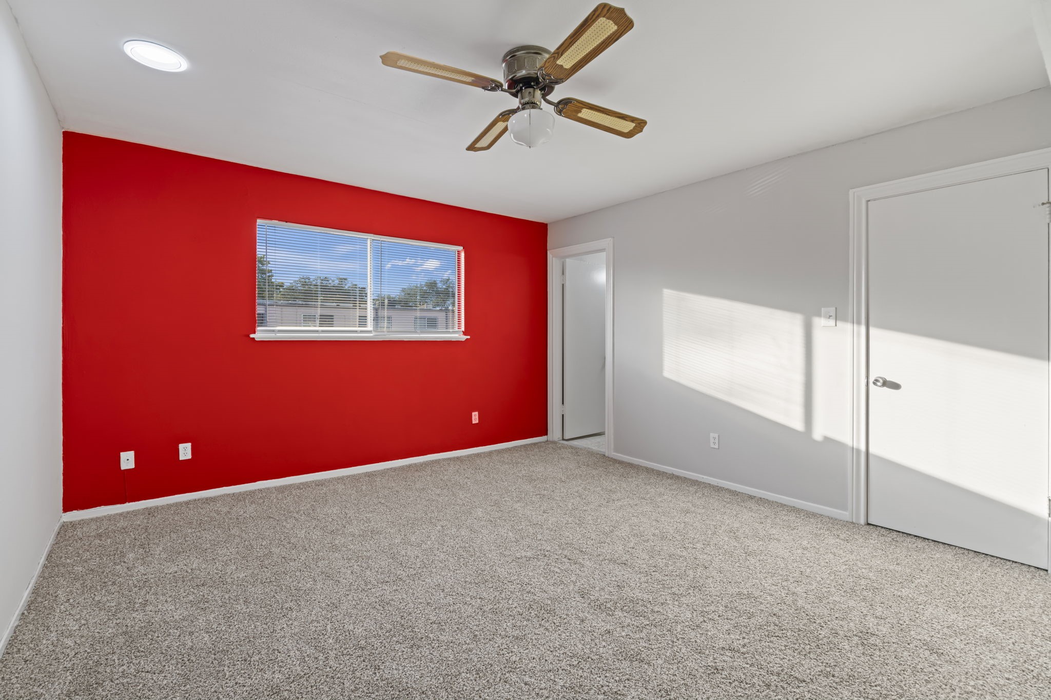 11607 Chimney Rock Road, Unit C Houston, TX 77035 - Photo 14 of 18 an empty room with windows and fan